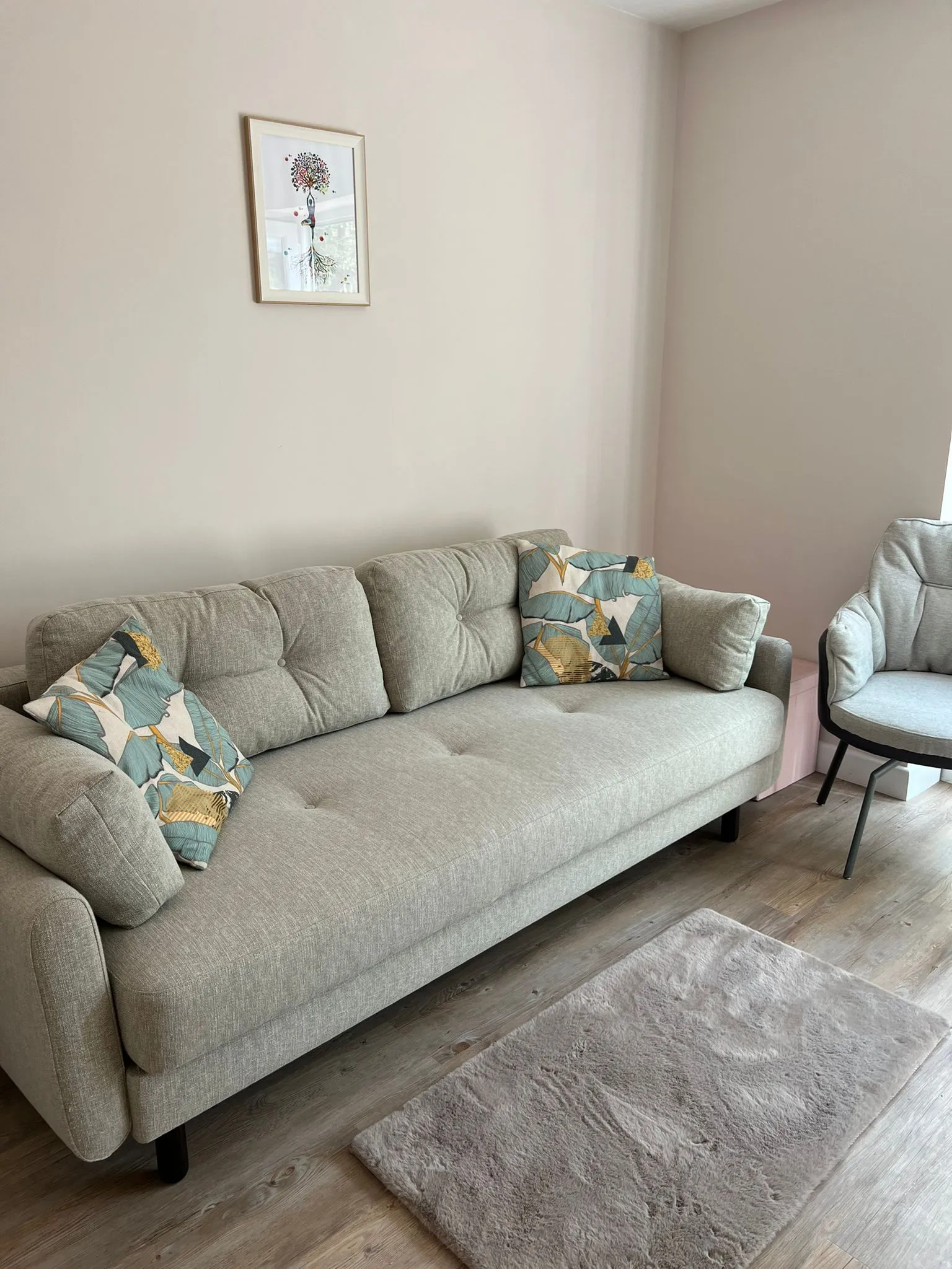 a living room with a couch, chair and rug