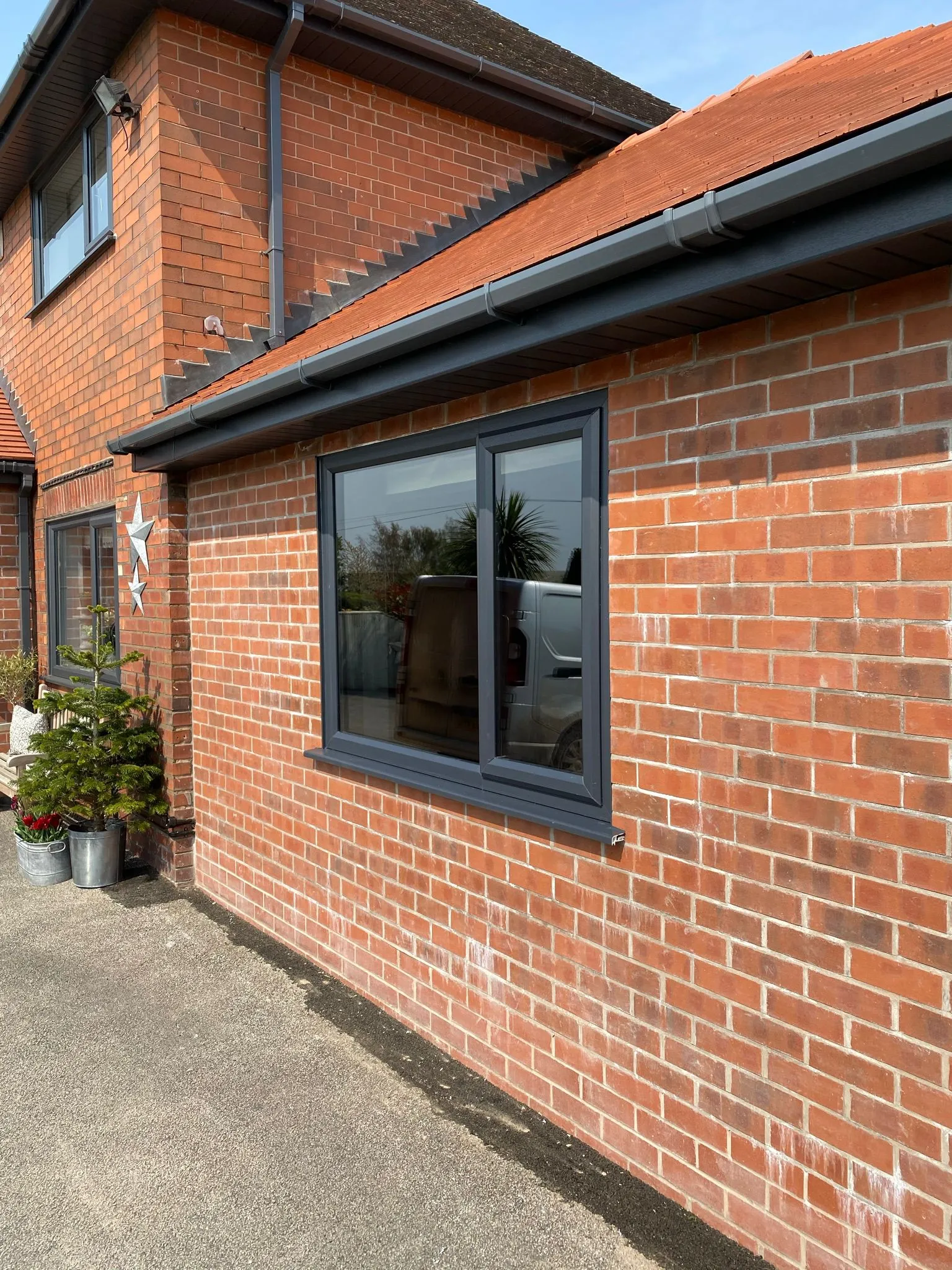 a brick building with a potted plant in front of it